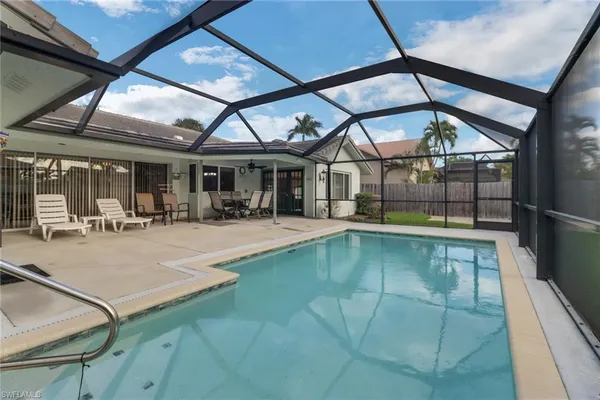 a view of swimming pool with outdoor seating