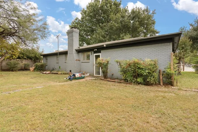 a view of a backyard with table and chairs and a fire pit