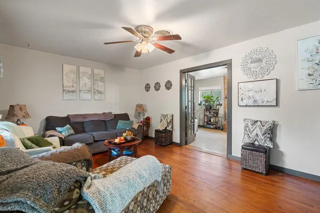 a living room with furniture and wooden floor