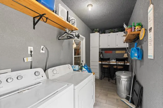a kitchen with a sink appliances and cabinets