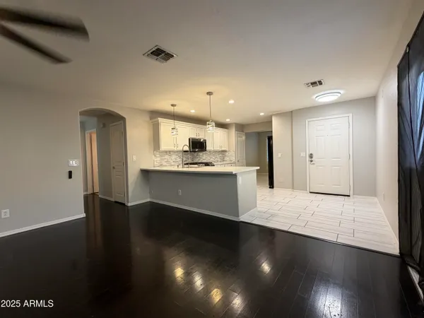 a view of a room with wooden floor
