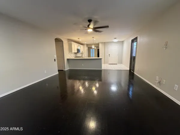 a large white kitchen with stainless steel appliances lots of counter space and cabinets