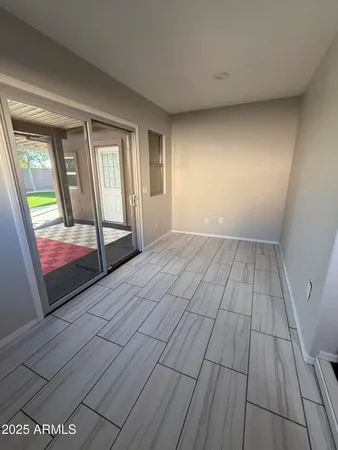 view of a room with wooden floor and staircase