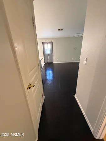 a view of an empty room with a ceiling fan