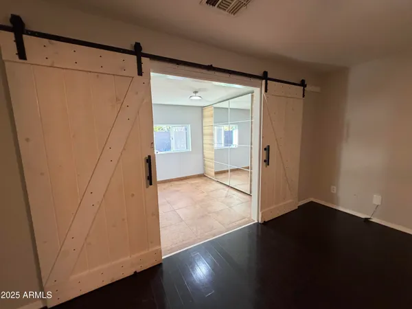 a view of a room with wooden floor and a window