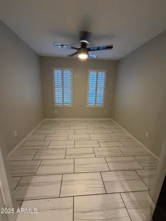 wooden floor in an empty room with a kitchen