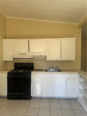 a kitchen with a sink and a refrigerator