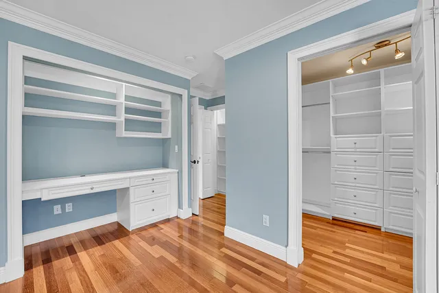 a view of walk in closet with empty racks