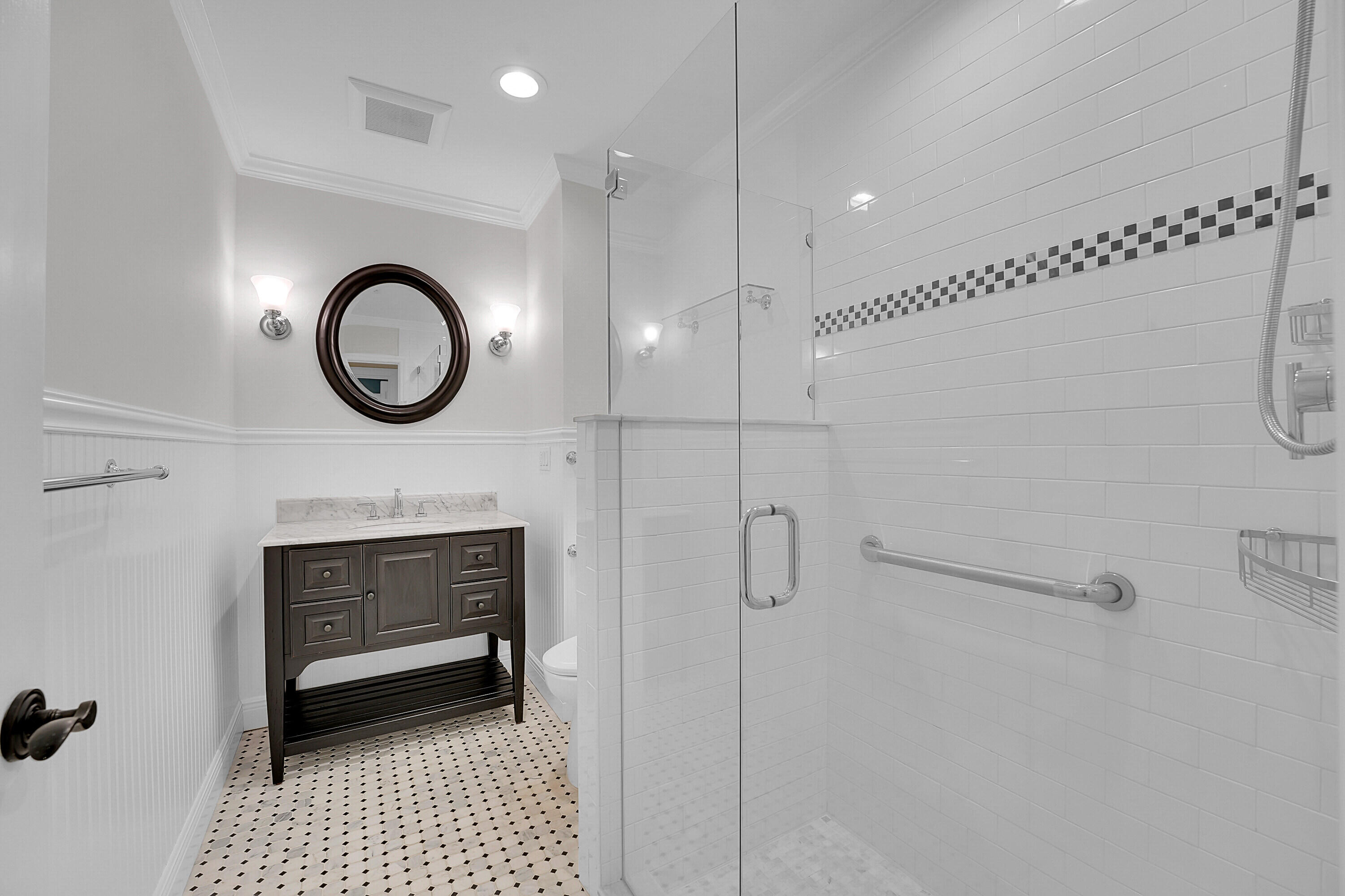 10 Middle Road Sewall's Point, FL 34996 - Photo 20 of 28 a bathroom with a sink a mirror and a shower