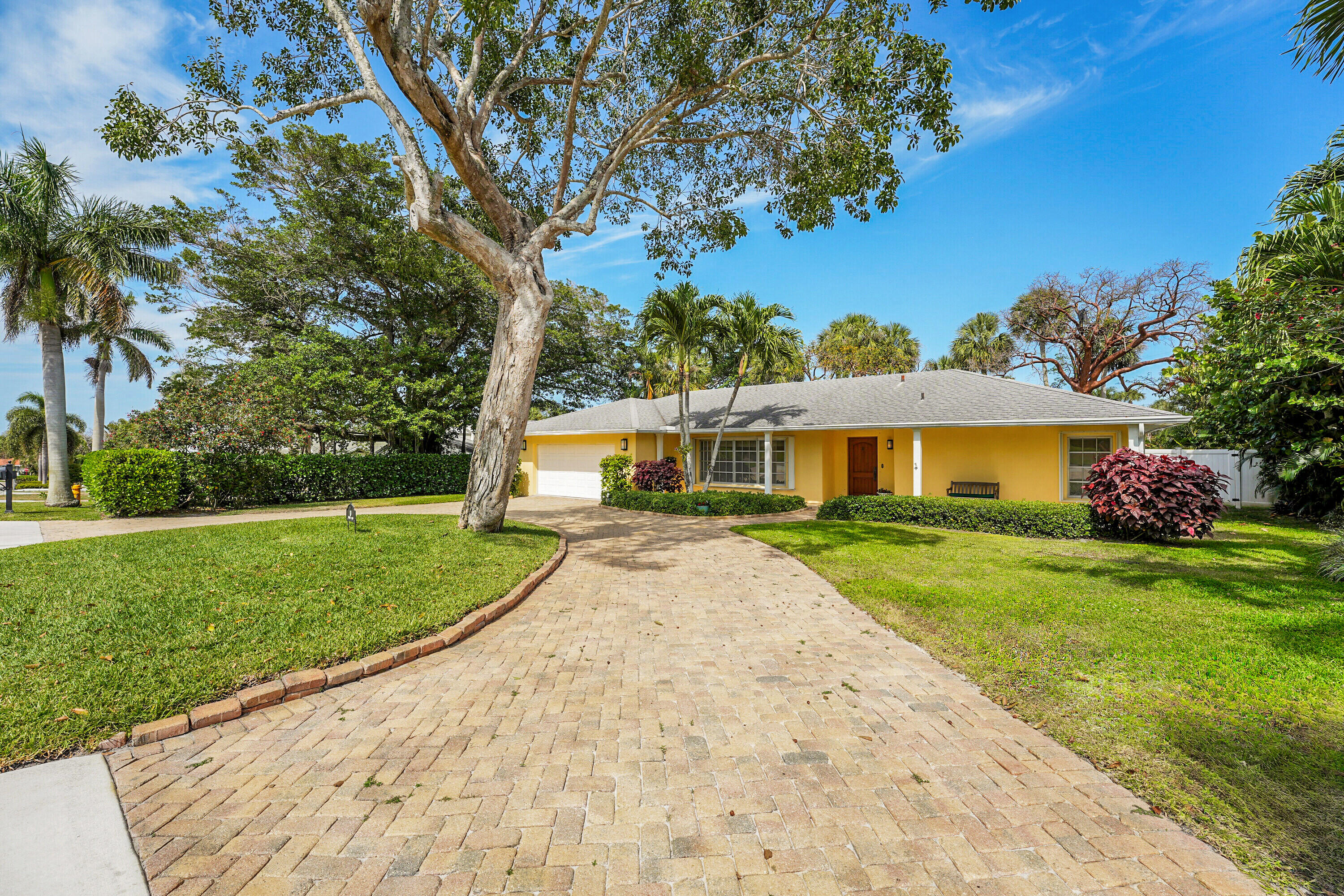 10 Middle Road Sewall's Point, FL 34996 - Photo 3 of 28 a front view of a house with a yard and potted plants