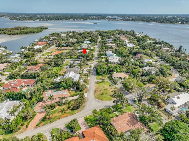 an aerial view of a house with a yard and lake view