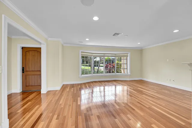 a kitchen with a refrigerator a stove top oven and white cabinets