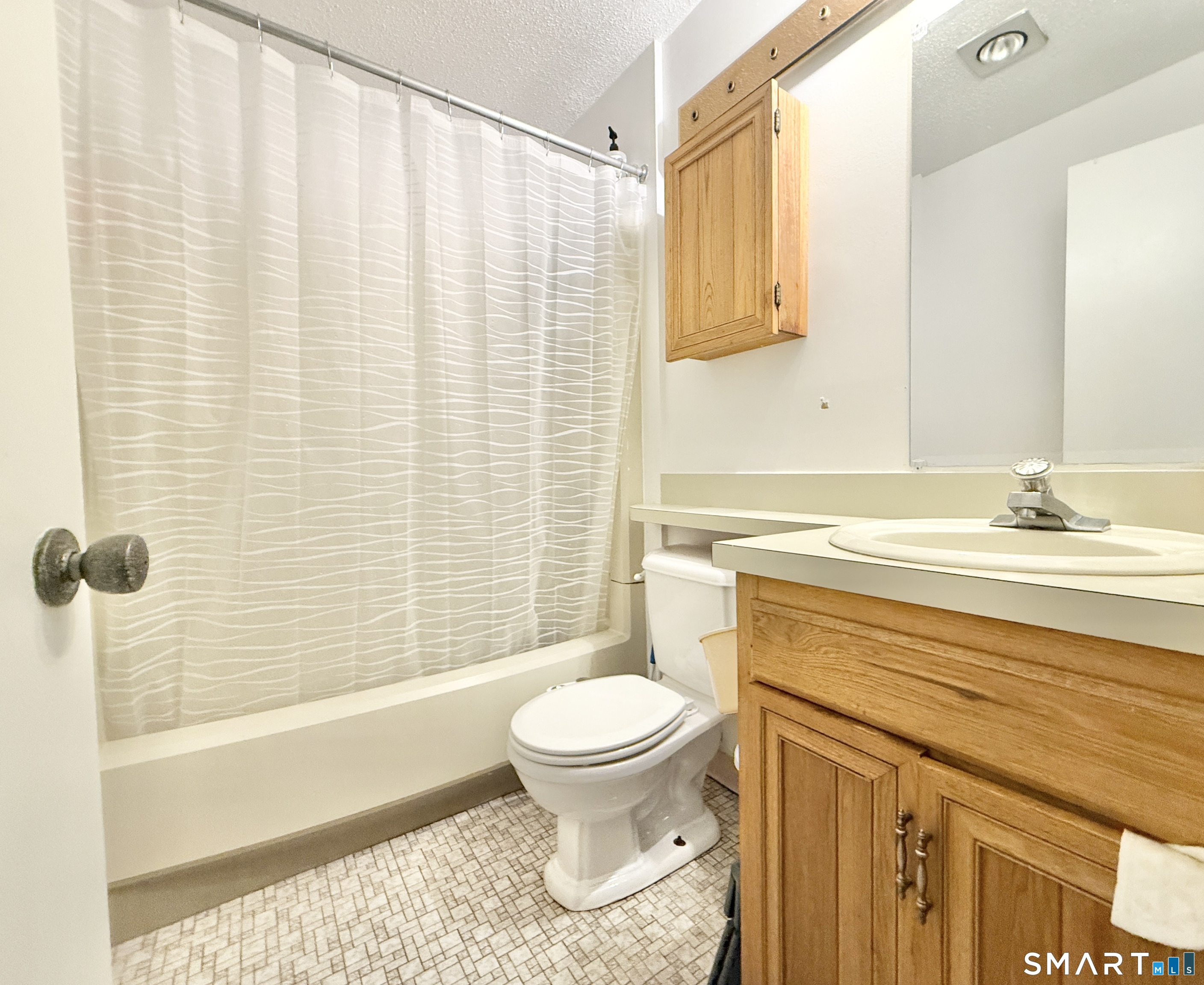 34 A Padanaram Road, Unit 127 Danbury, CT 06811 - Photo 10 of 13 a bathroom with a sink a toilet and a shower