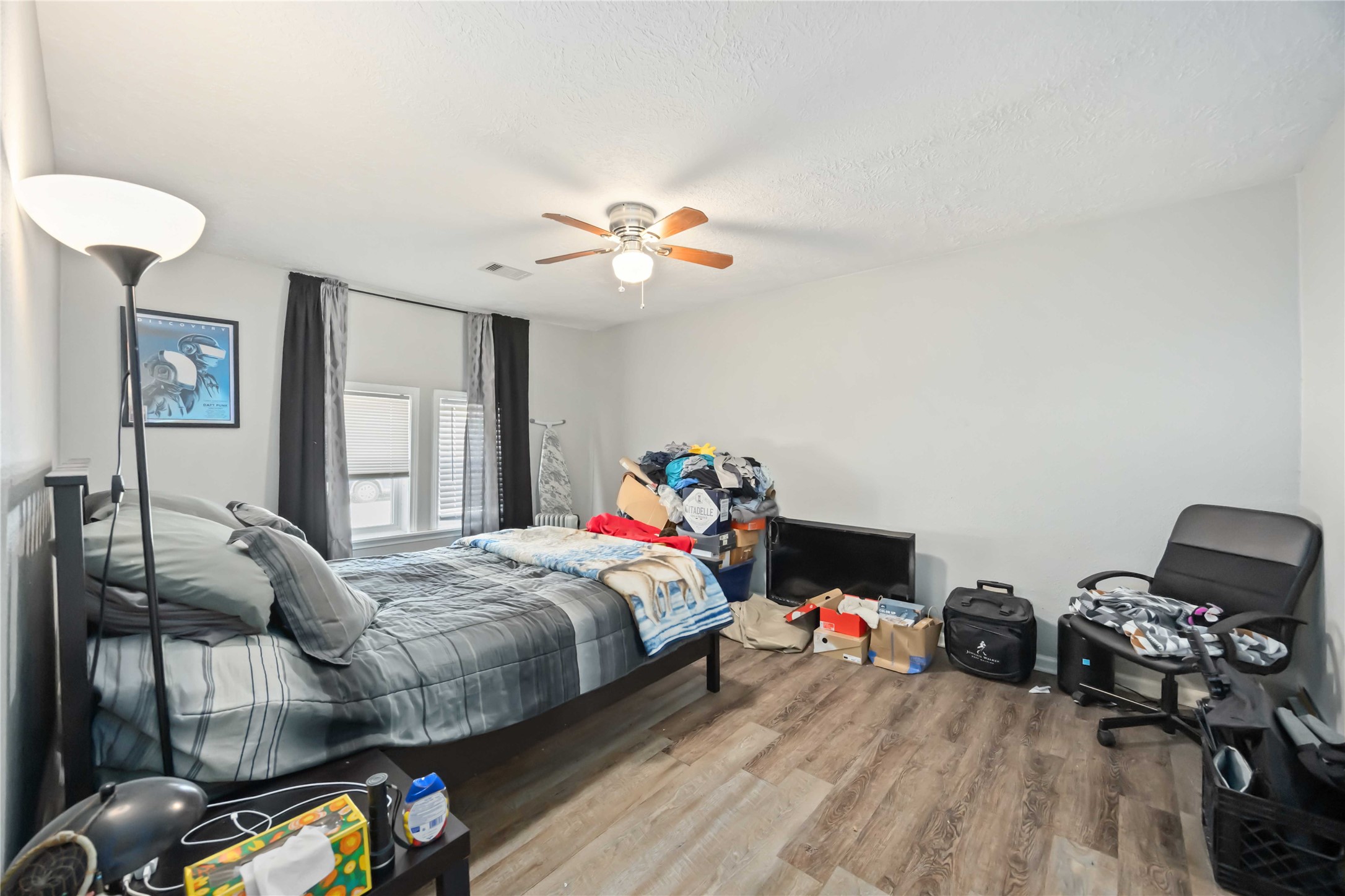 3710 Bremond Street Houston, TX 77004 - Photo 13 of 30 a bedroom with bed and a chandelier