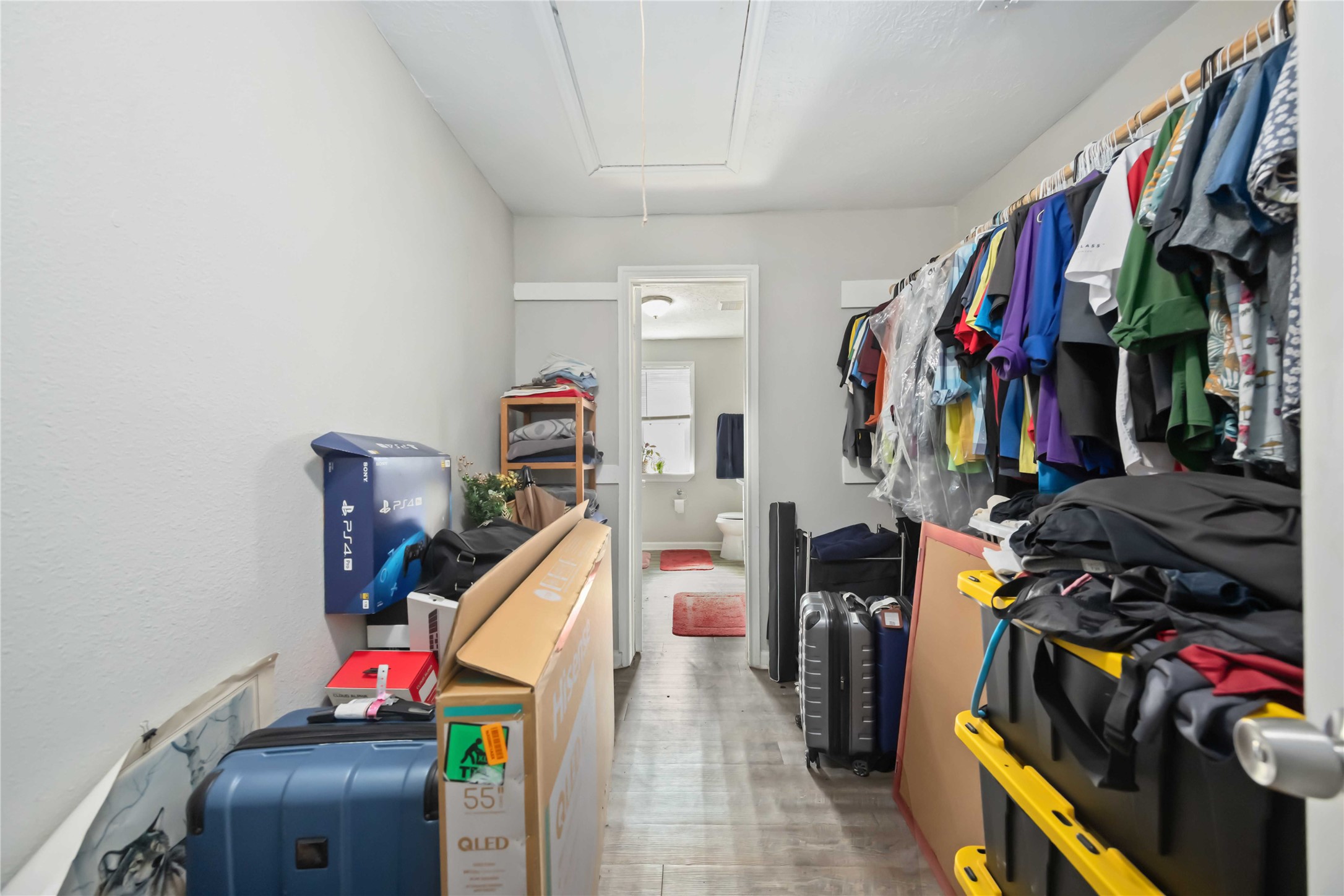 3710 Bremond Street Houston, TX 77004 - Photo 15 of 30 a view of walk in closet with clothes and shoes