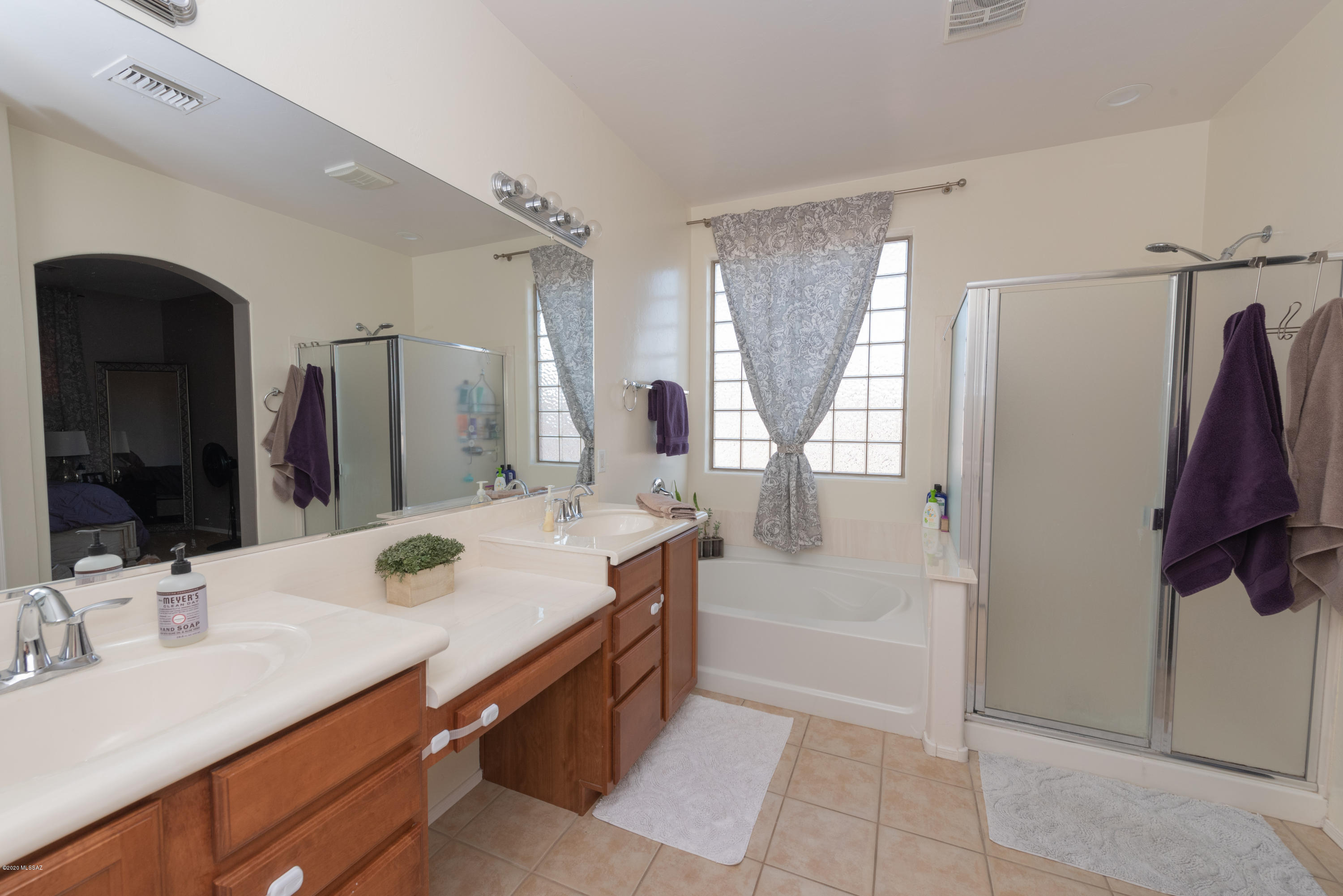 12910 Bloomington Loop Oro Valley, AZ 85755 - Photo 22 of 30 a bathroom with a tub sink and mirror