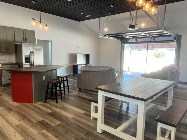 a kitchen with stainless steel appliances granite countertop a stove a refrigerator and a dining table