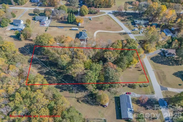 an aerial view of a houses with yard
