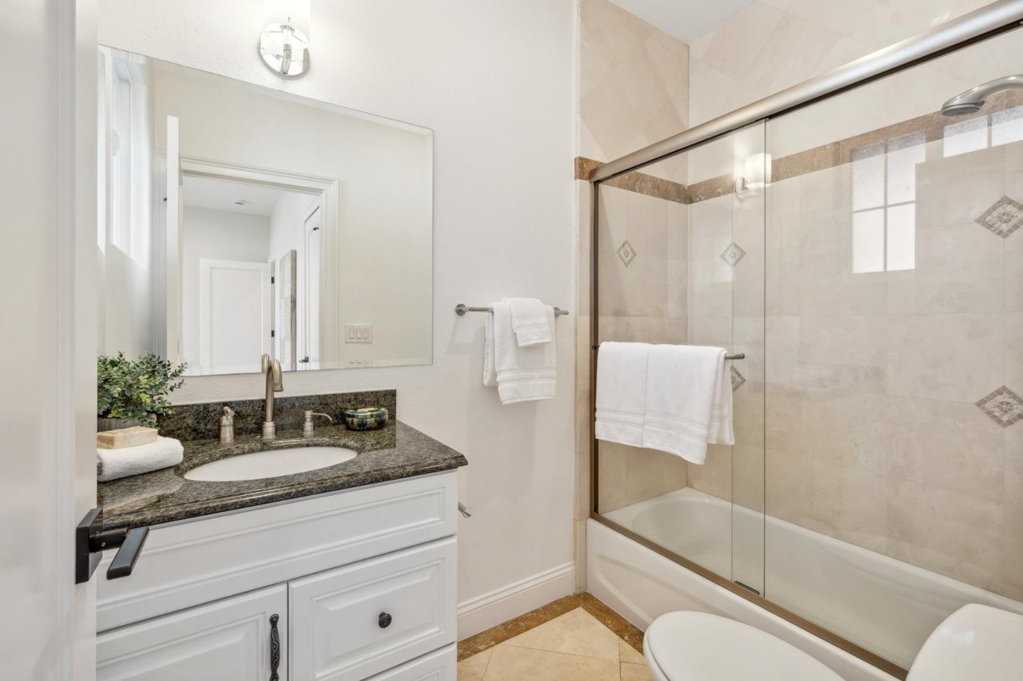 14574 Nelson Way San Jose, CA 95124 - Photo 27 of 62 a bathroom with a granite countertop sink a toilet and shower
