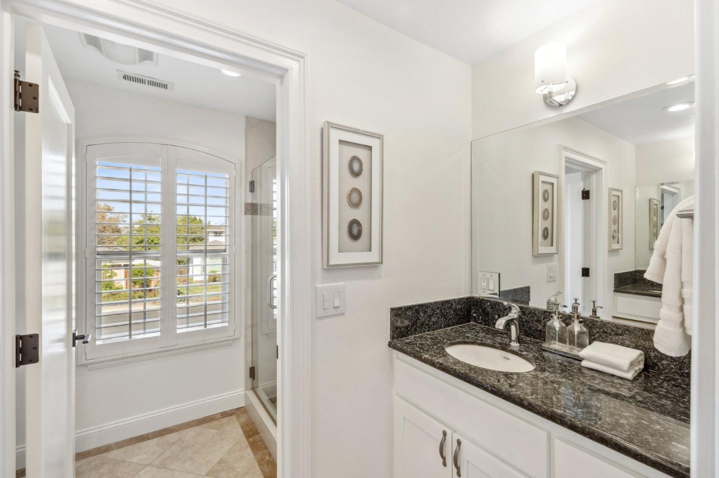 14574 Nelson Way San Jose, CA 95124 - Photo 46 of 62 a bathroom with double vanity sinks a mirror and a shower