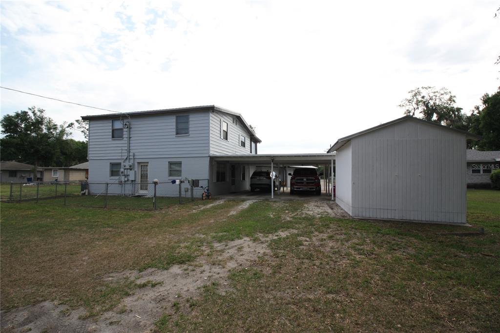 521 20th Street Southwest, Unit C Winter Haven, FL 33880 - Photo 15 of 18 a view of a house with a backyard