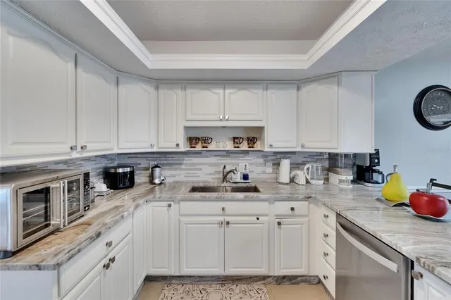 a bathroom with a granite countertop shower sink and vanity