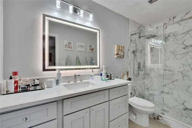 a view of a patio with table and chairs under an umbrella