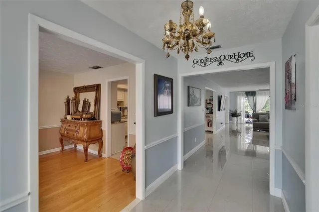 a living room with furniture fireplace and a large window