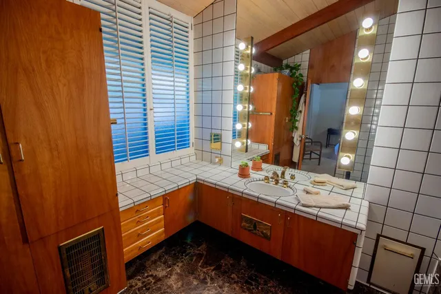 a view of walk in closet with clothes