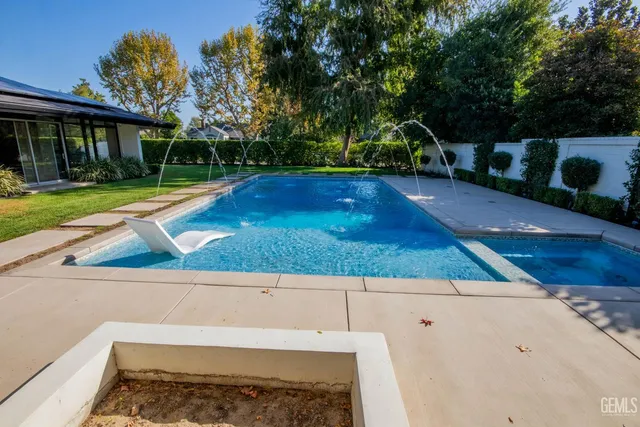 a view of house with swimming pool yard