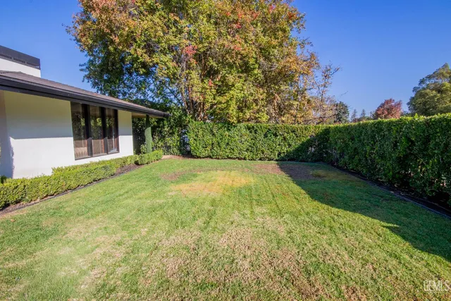 an aerial view of a house with a yard basket ball court and outdoor seating