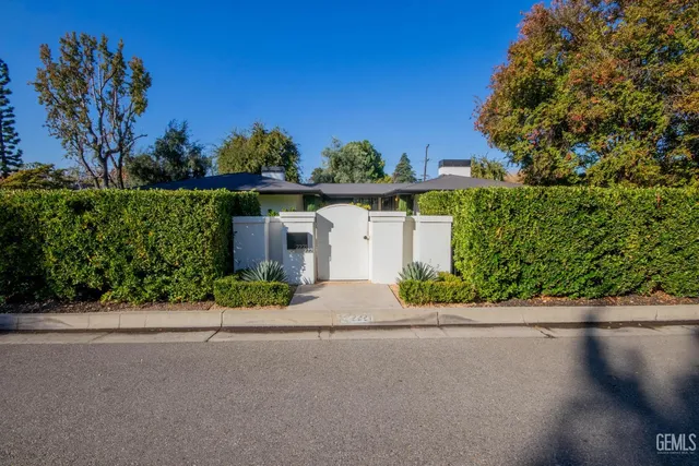 a view of a hallway with wooden floor and stairs