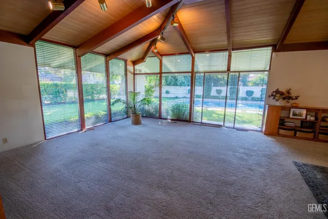 a living room with furniture fireplace and a large window