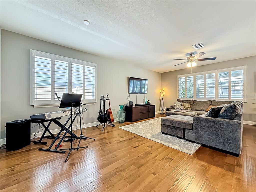 10193 Grand Oak Circle Madeira Beach, FL 33708 - Photo 11 of 67 a living room with furniture and a window