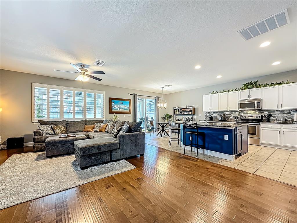 10193 Grand Oak Circle Madeira Beach, FL 33708 - Photo 12 of 67 a living room with stainless steel appliances furniture and a kitchen view