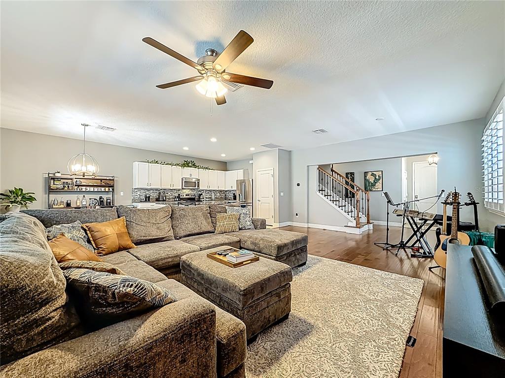 10193 Grand Oak Circle Madeira Beach, FL 33708 - Photo 13 of 67 a living room with furniture kitchen view and a wooden floor
