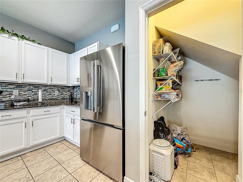 10193 Grand Oak Circle Madeira Beach, FL 33708 - Photo 15 of 67 a kitchen with stainless steel appliances a refrigerator and a sink