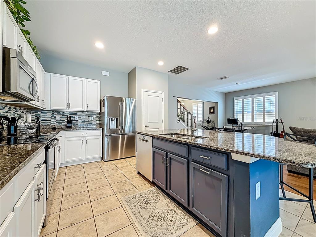 10193 Grand Oak Circle Madeira Beach, FL 33708 - Photo 20 of 67 a large kitchen with granite countertop lots of counter space and sink
