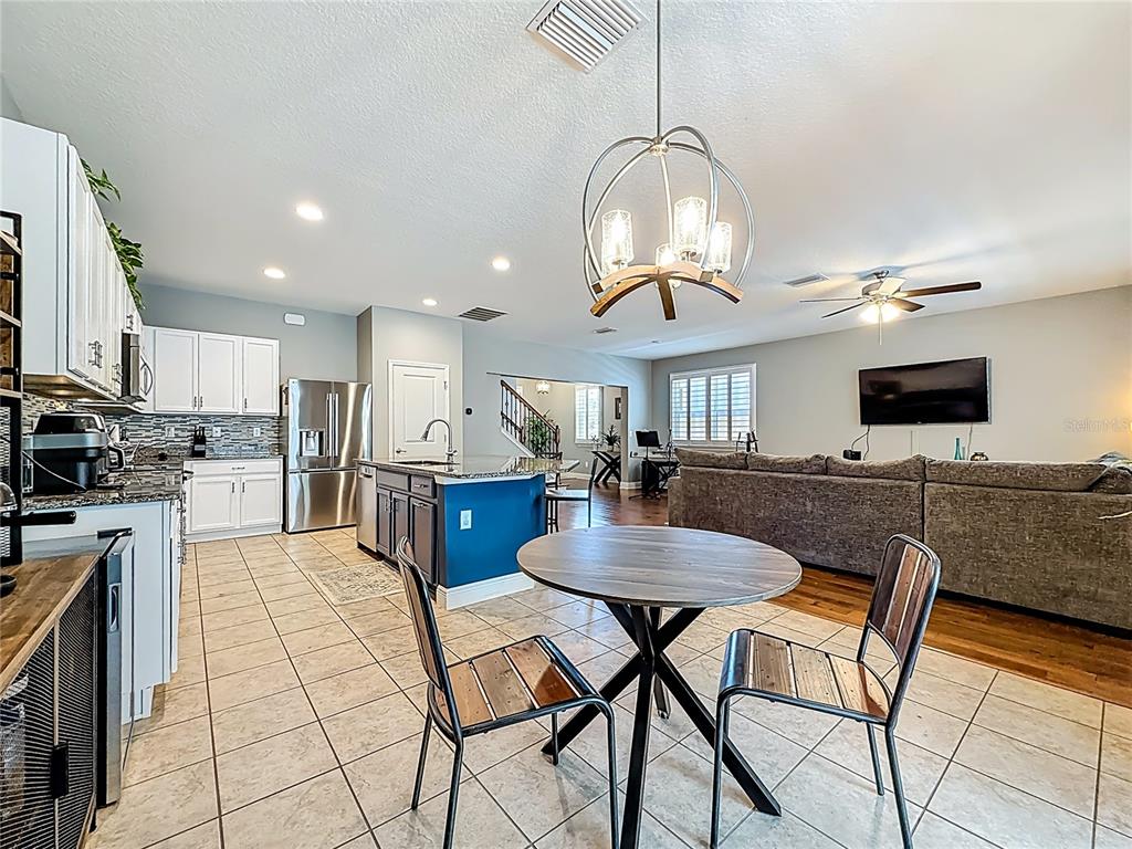 10193 Grand Oak Circle Madeira Beach, FL 33708 - Photo 23 of 67 a kitchen with stainless steel appliances kitchen island granite countertop a sink and cabinets