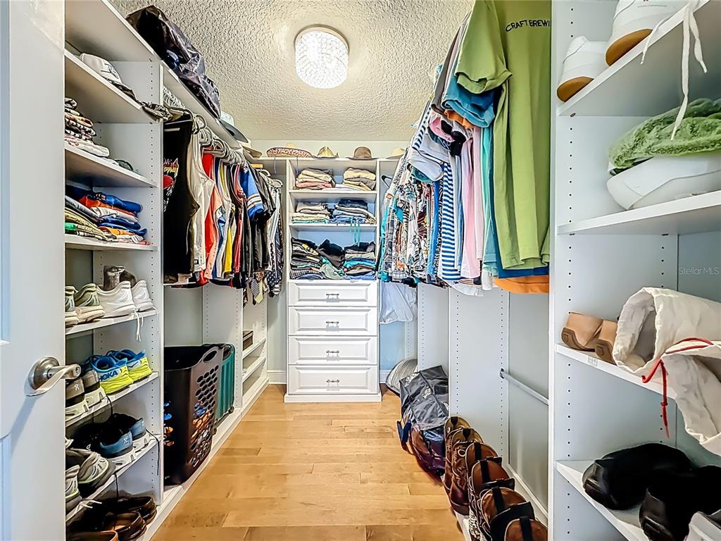 10193 Grand Oak Circle Madeira Beach, FL 33708 - Photo 30 of 67 a view of walk in closet with clothes and shoes