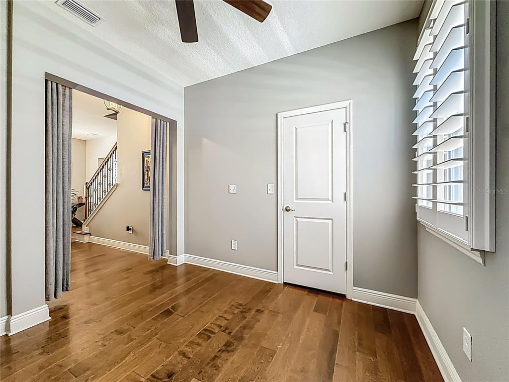 10193 Grand Oak Circle Madeira Beach, FL 33708 - Photo 32 of 67 an empty room with window and wooden floor