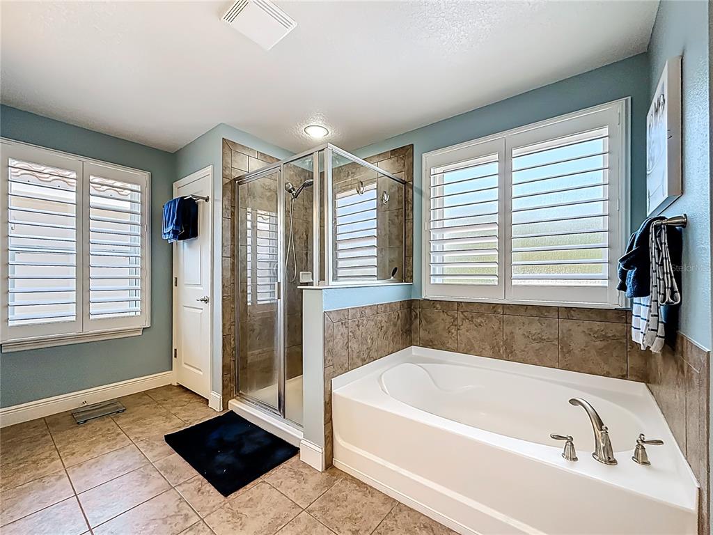 10193 Grand Oak Circle Madeira Beach, FL 33708 - Photo 34 of 67 a bathroom with a bathtub and a shower
