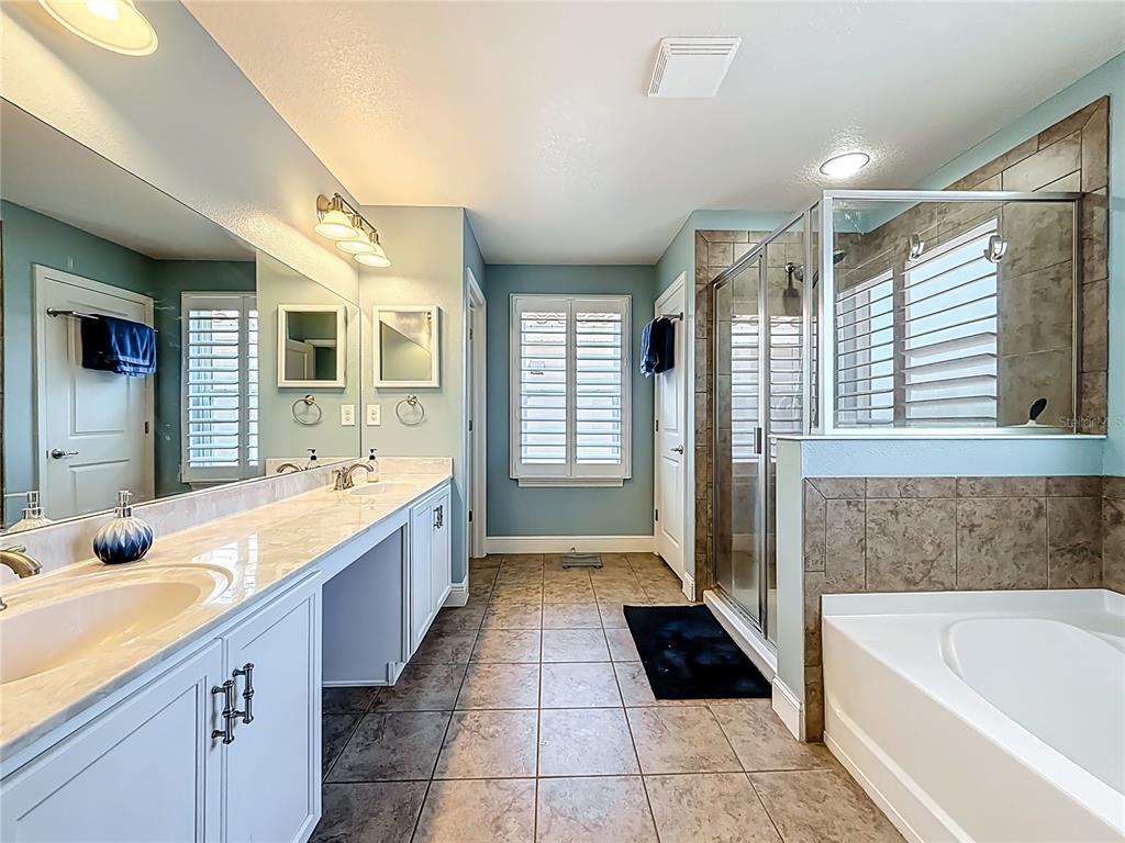 10193 Grand Oak Circle Madeira Beach, FL 33708 - Photo 35 of 67 a large spacious bathroom with a large tub shower and sink