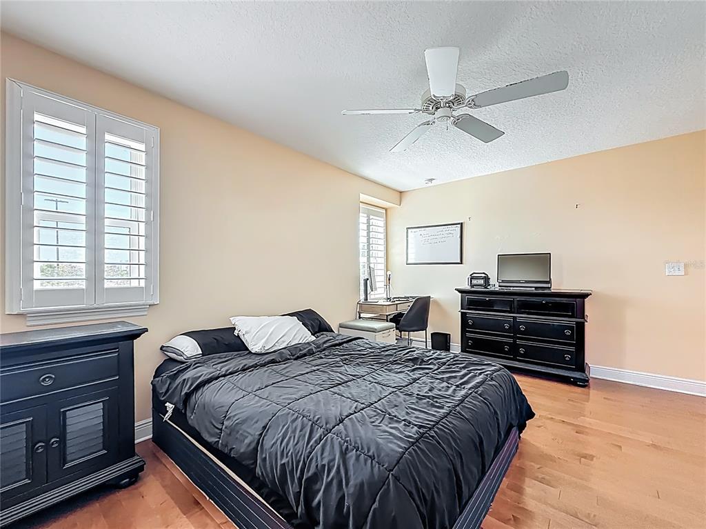 10193 Grand Oak Circle Madeira Beach, FL 33708 - Photo 38 of 67 a bedroom with a bed and a dresser