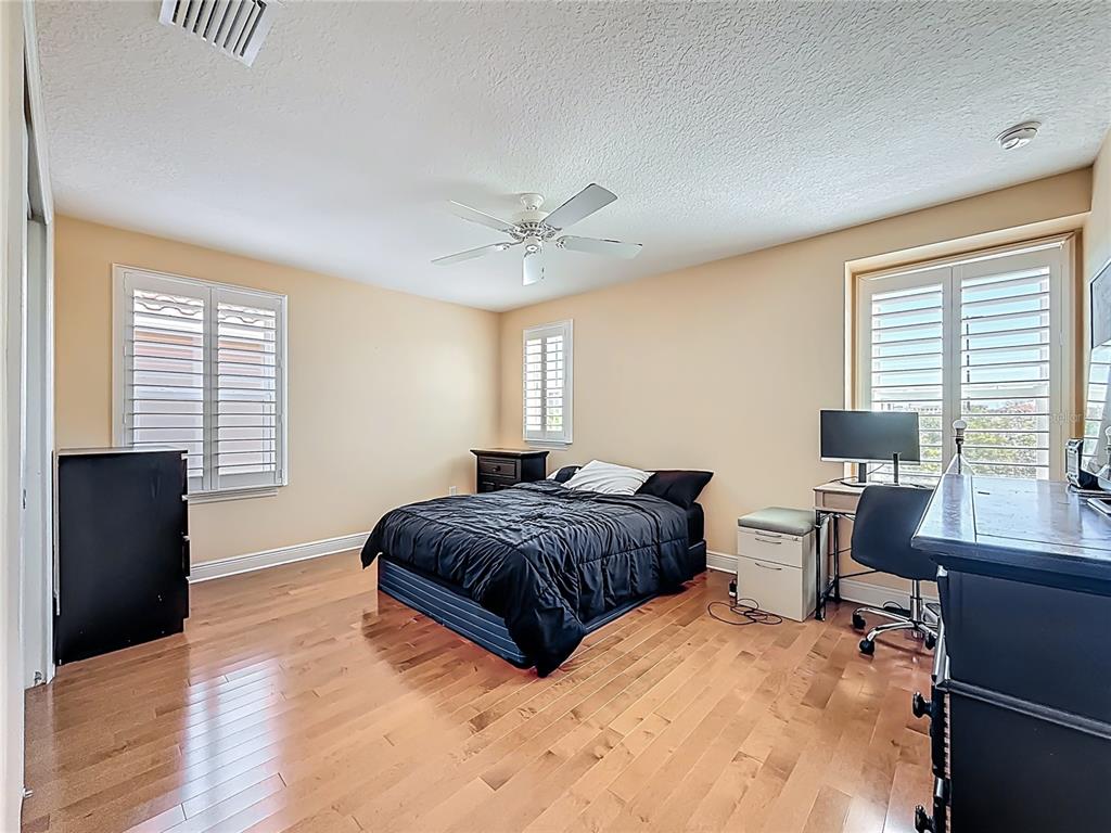 10193 Grand Oak Circle Madeira Beach, FL 33708 - Photo 39 of 67 a bedroom with a large bed and a window