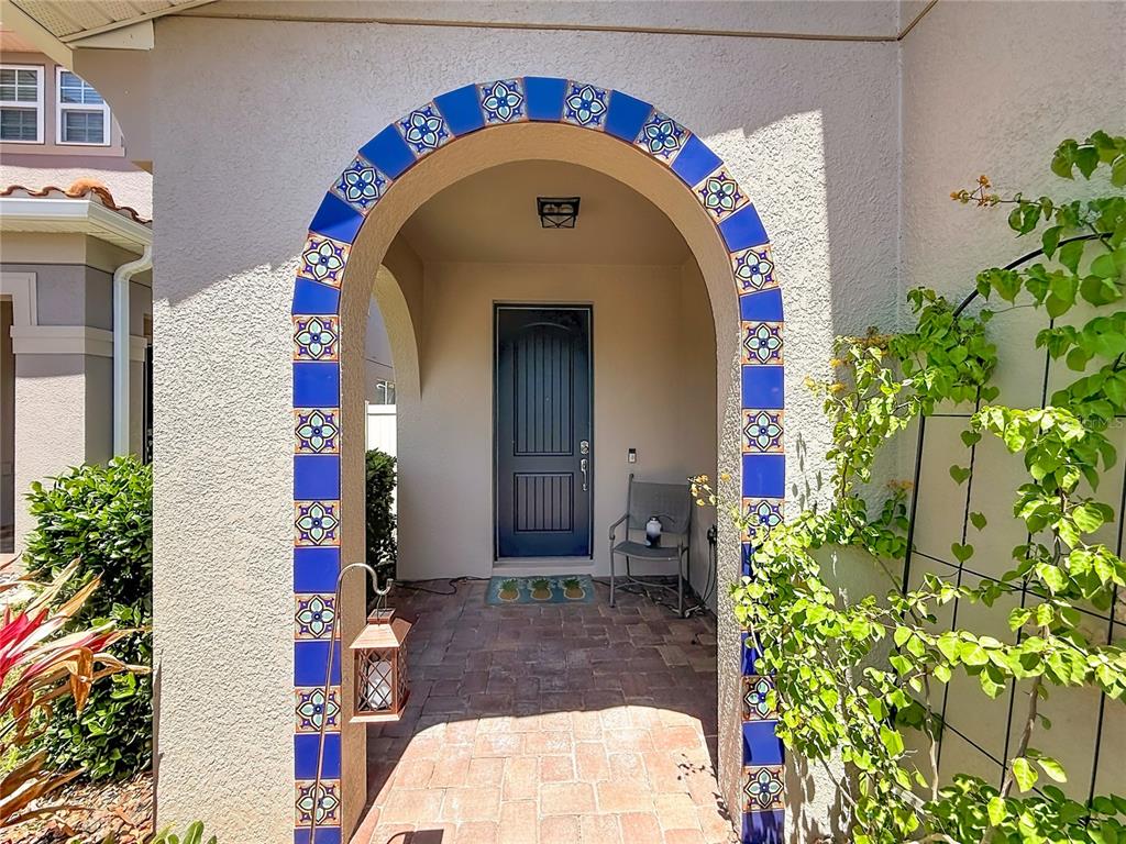 10193 Grand Oak Circle Madeira Beach, FL 33708 - Photo 4 of 67 a front view of a house with a garden