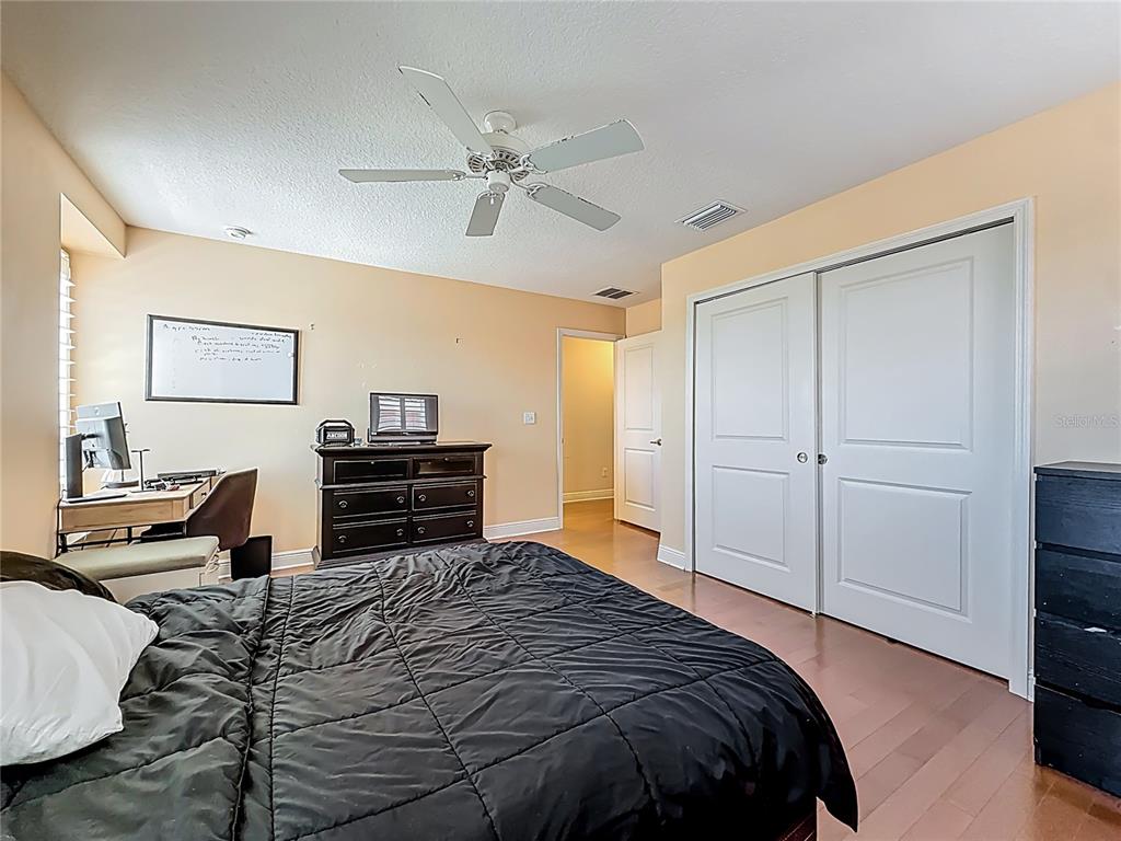 10193 Grand Oak Circle Madeira Beach, FL 33708 - Photo 41 of 67 a bedroom with a bed and a chandelier