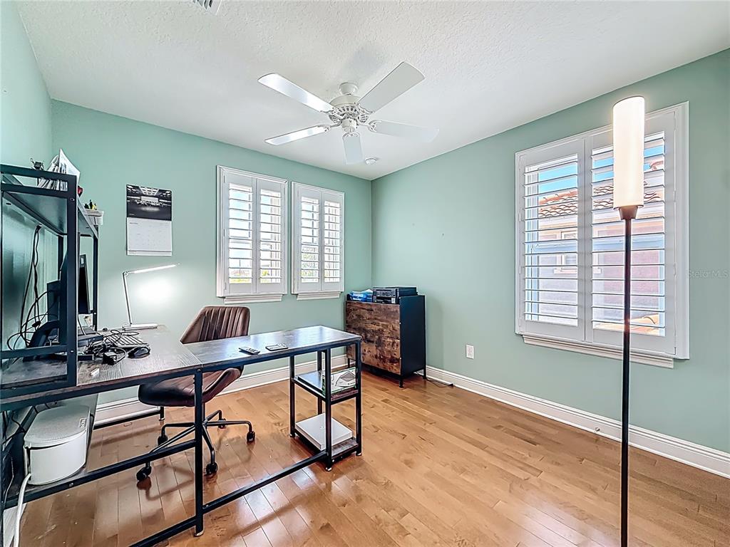 10193 Grand Oak Circle Madeira Beach, FL 33708 - Photo 44 of 67 a view of a workspace with furniture and a window
