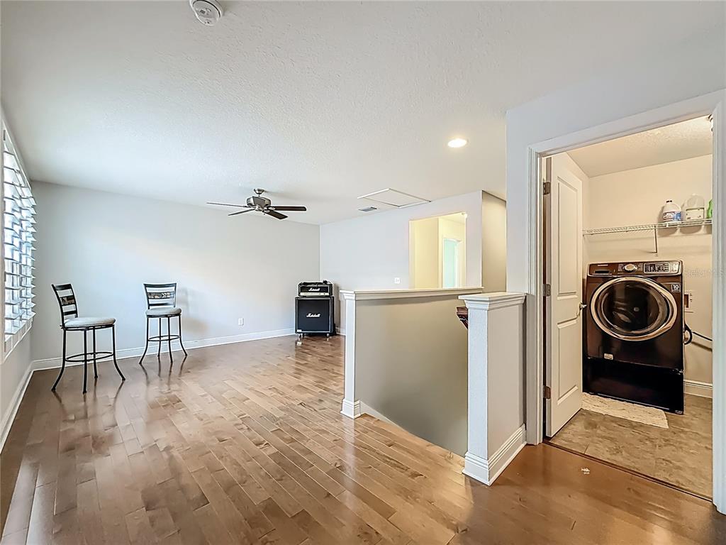 10193 Grand Oak Circle Madeira Beach, FL 33708 - Photo 49 of 67 a view of a livingroom with furniture and a kitchen