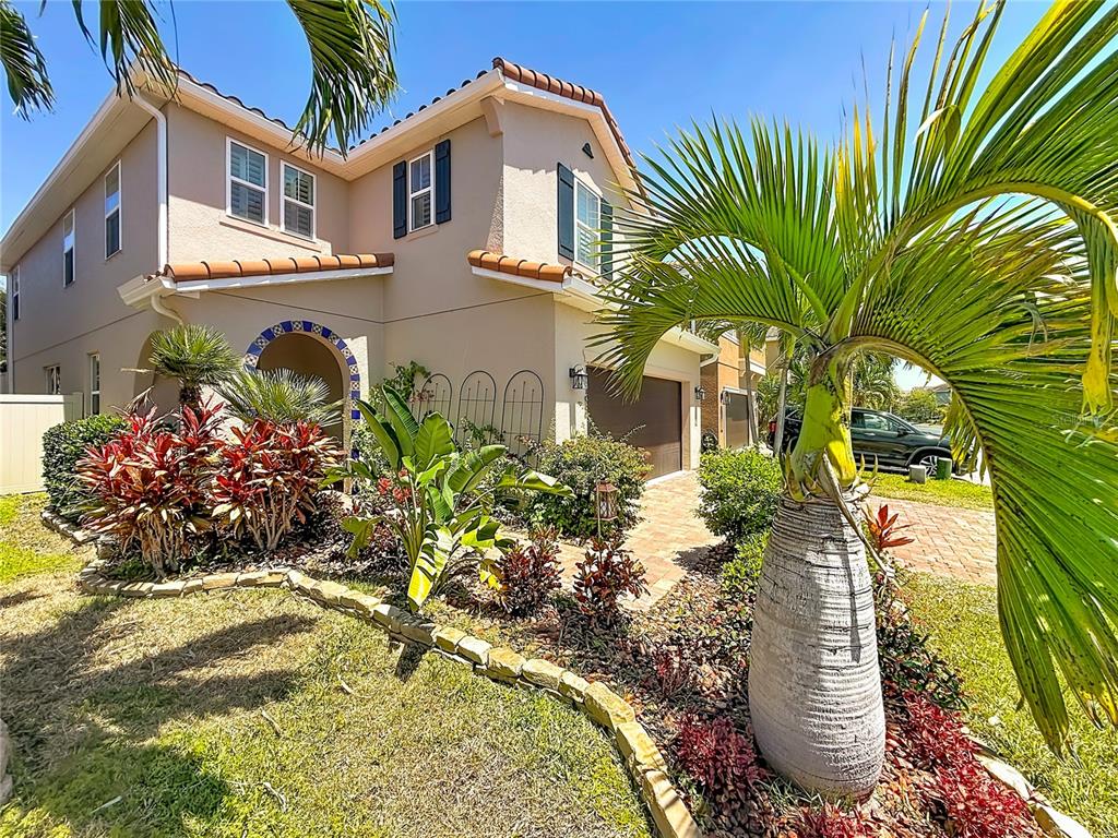 10193 Grand Oak Circle Madeira Beach, FL 33708 - Photo 5 of 67 a front view of a house with a yard